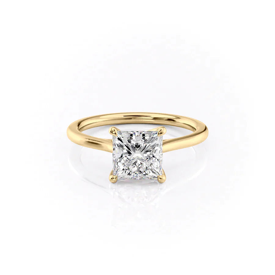 The Lexie. A Yellow Gold Solitaire Engagement Ring Set With A 2ct Princess Lab Grown Diamond. White Background.