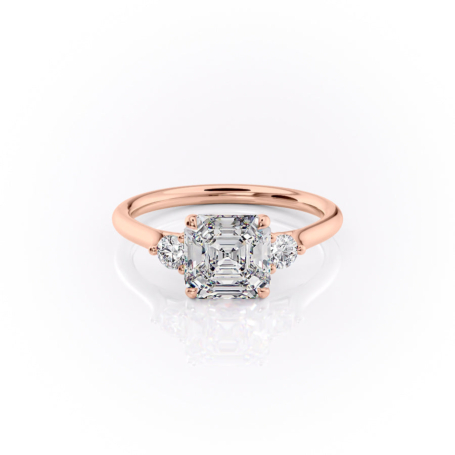 The Lia. A Rose Gold Three Stone Engagement Ring Set With A 2ct Asscher Lab Grown Diamond. White Background.