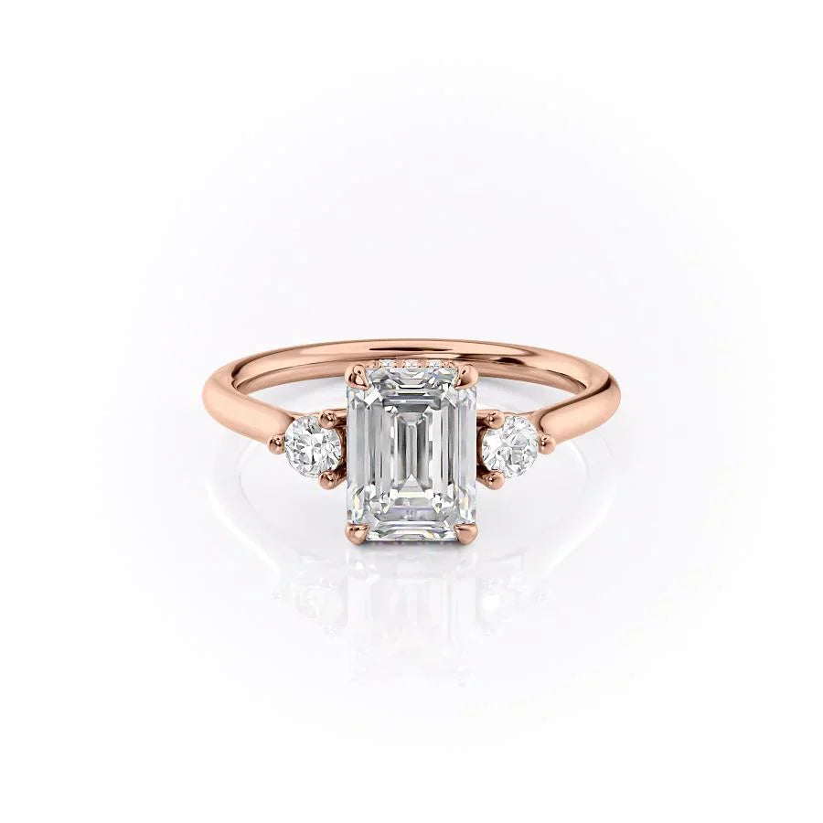 The Lia. A Rose Gold Three Stone Engagement Ring Set With A 2ct Emerald Lab Grown Diamond. White Background.