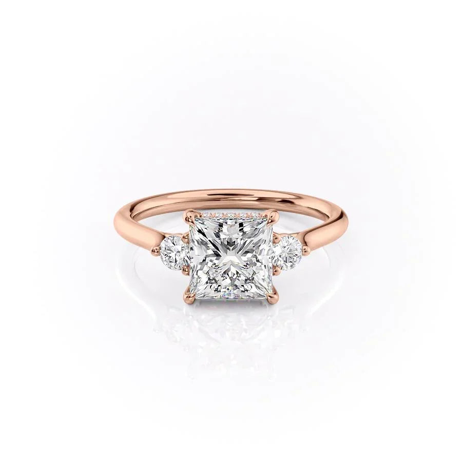 The Lia. A Rose Gold Three Stone Engagement Ring Set With A 2ct Princess Lab Grown Diamond. White Background.