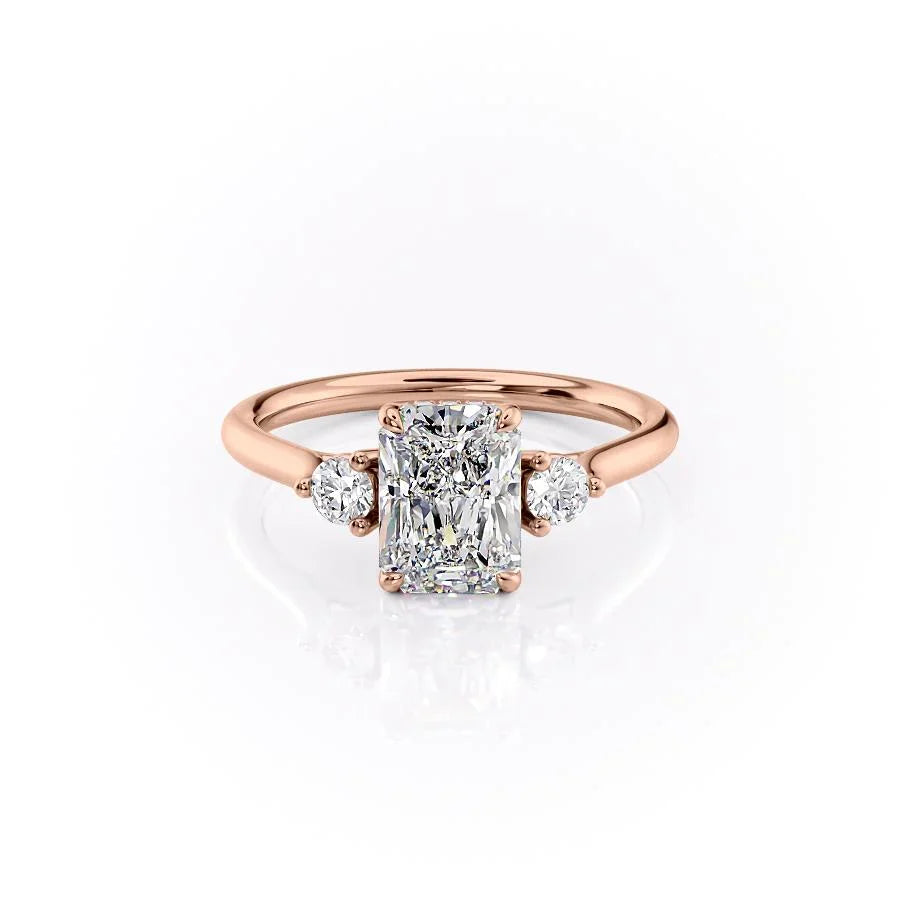 The Lia. A Rose Gold Three Stone Engagement Ring Set With A 2ct Radiant Lab Grown Diamond. White Background.