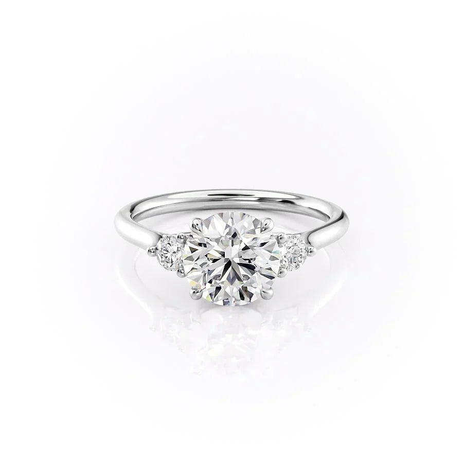 The Lia. A White Gold Three Stone Engagement Ring Set With A 2ct Round Lab Grown Diamond. White Background.