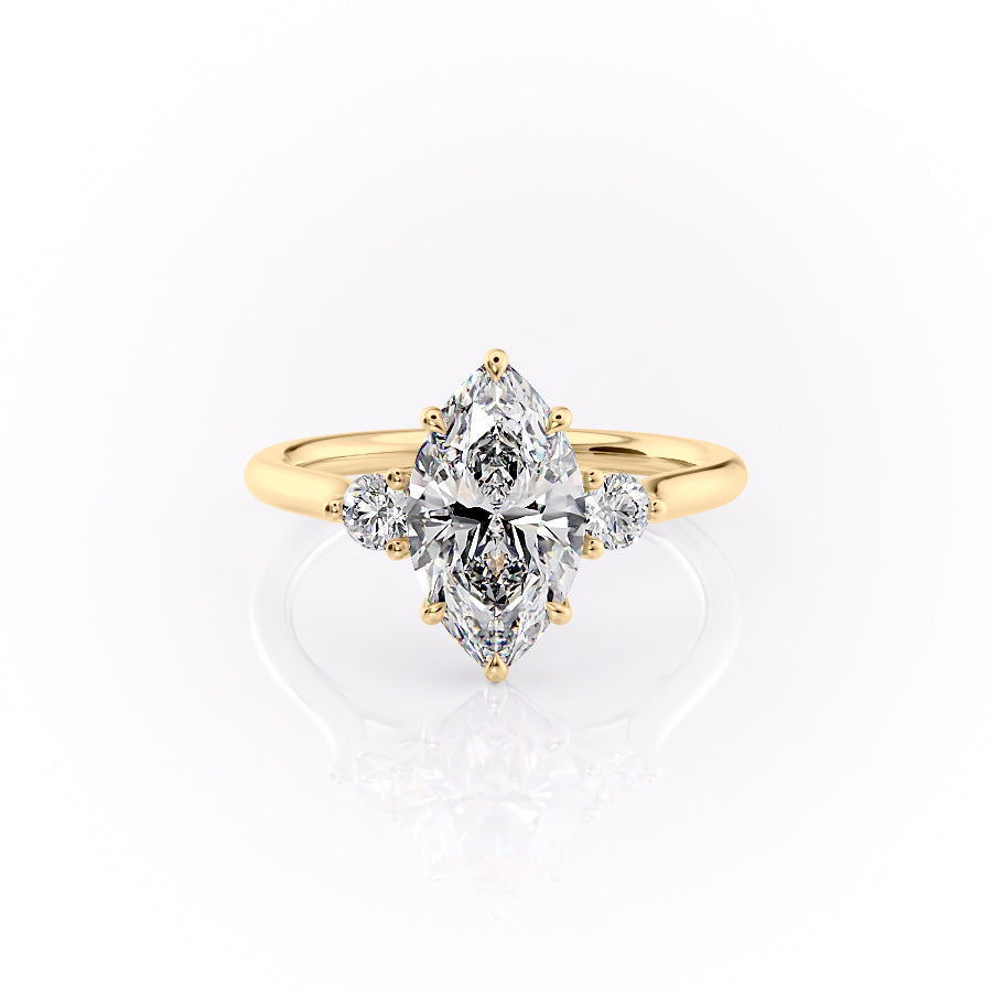 The Lia. A Yellow Gold Three Stone Engagement Ring Set With A 2ct Marquise Lab Grown Diamond. White Background.