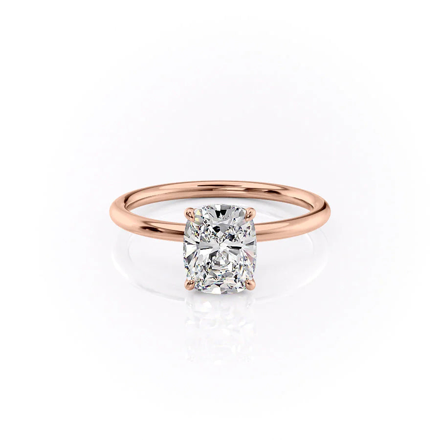 The Lily. A Rose Gold Solitaire, Nature Engagement Ring Set With A 2ct Elongated Cushion Lab Grown Diamond. White Background.