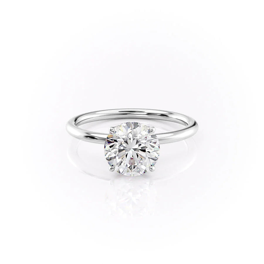 The Lily. A White Gold Solitaire, Nature Engagement Ring Set With A 2ct Round Lab Grown Diamond. White Background.