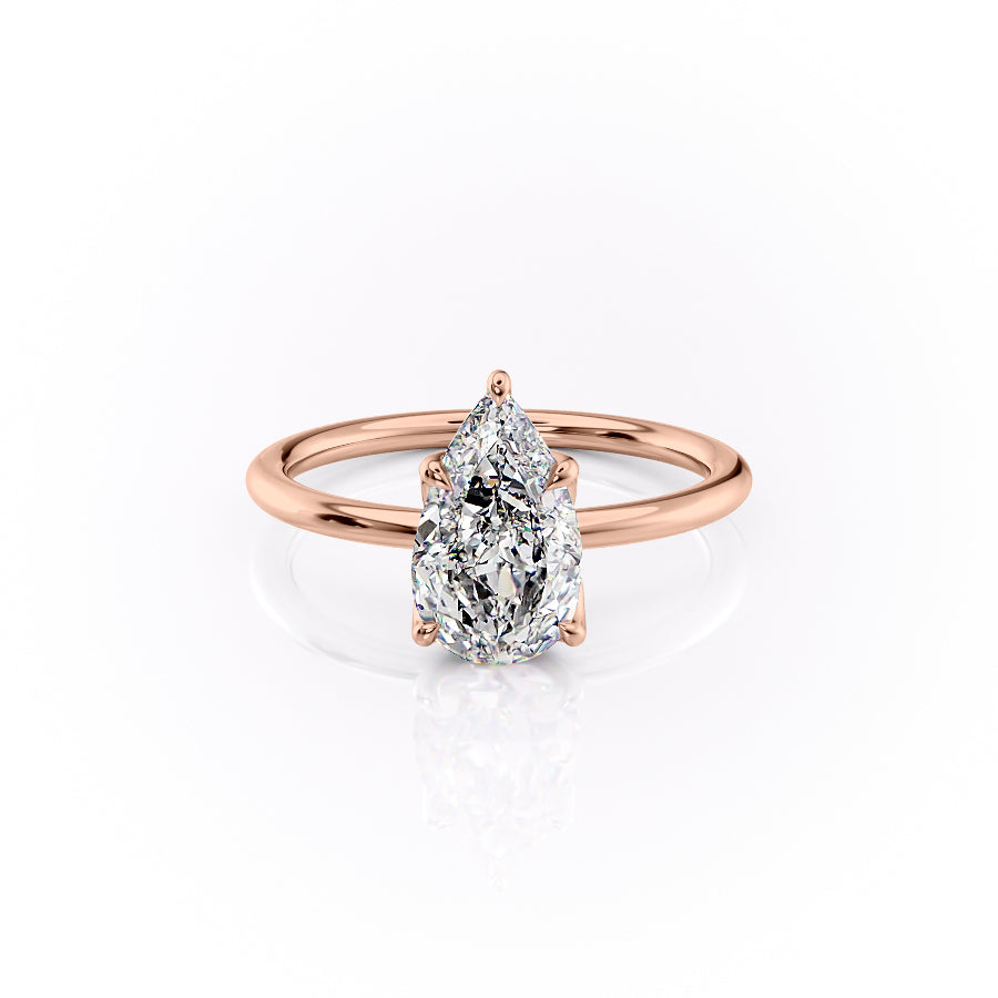 The Lisa. A Rose Gold Solitaire, Nature Engagement Ring Set With A 2ct Pear Lab Grown Diamond. White Background.