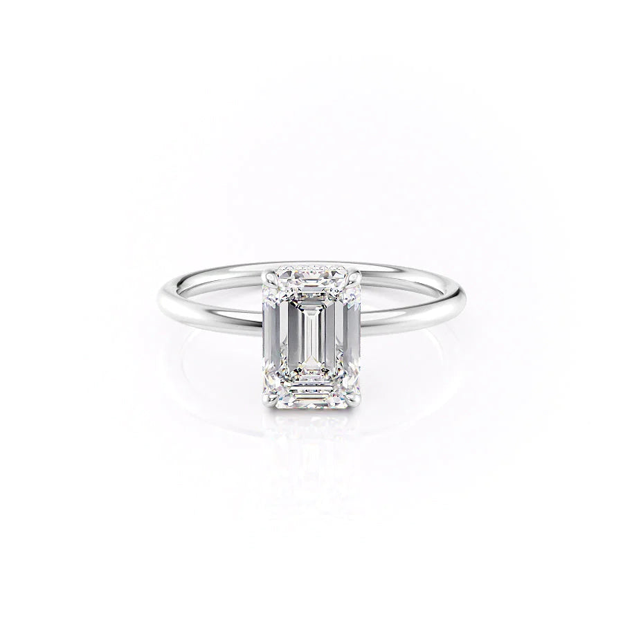 The Low Profile Kamellie. A White Gold Solitaire, Hidden Halo Engagement Ring Set With A 2ct Emerald Lab Grown Diamond. White Background.