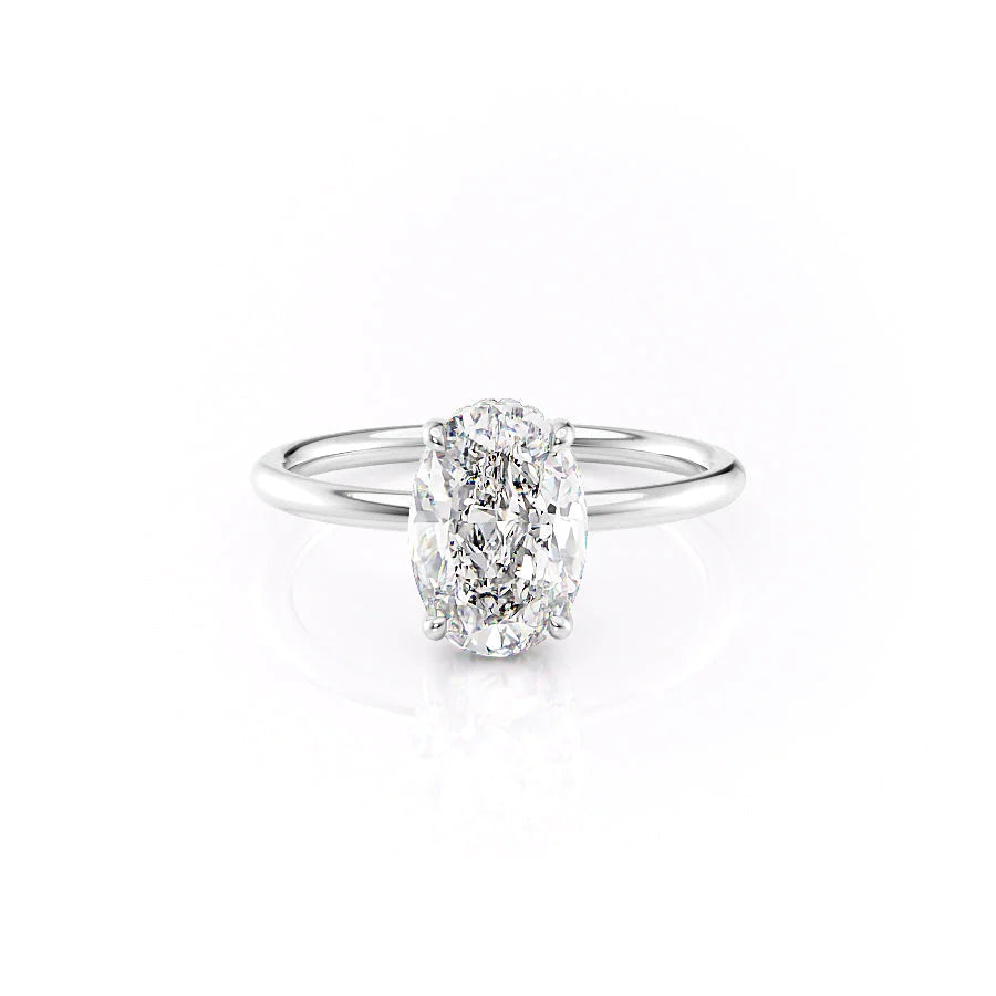 The Low Profile Kamellie. A White Gold Solitaire, Hidden Halo Engagement Ring Set With A 2ct Oval Lab Grown Diamond. White Background.