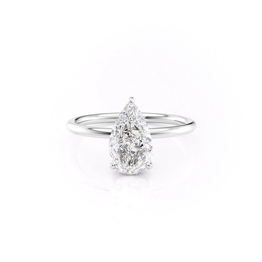 The Low Profile Kamellie. A White Gold Solitaire, Hidden Halo Engagement Ring Set With A 2ct Pear Lab Grown Diamond. White Background.