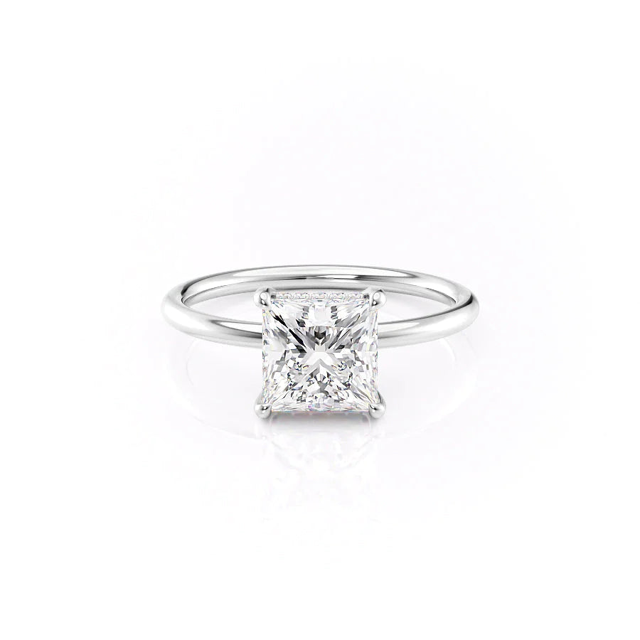 The Low Profile Kamellie. A White Gold Solitaire, Hidden Halo Engagement Ring Set With A 2ct Princess Lab Grown Diamond. White Background.