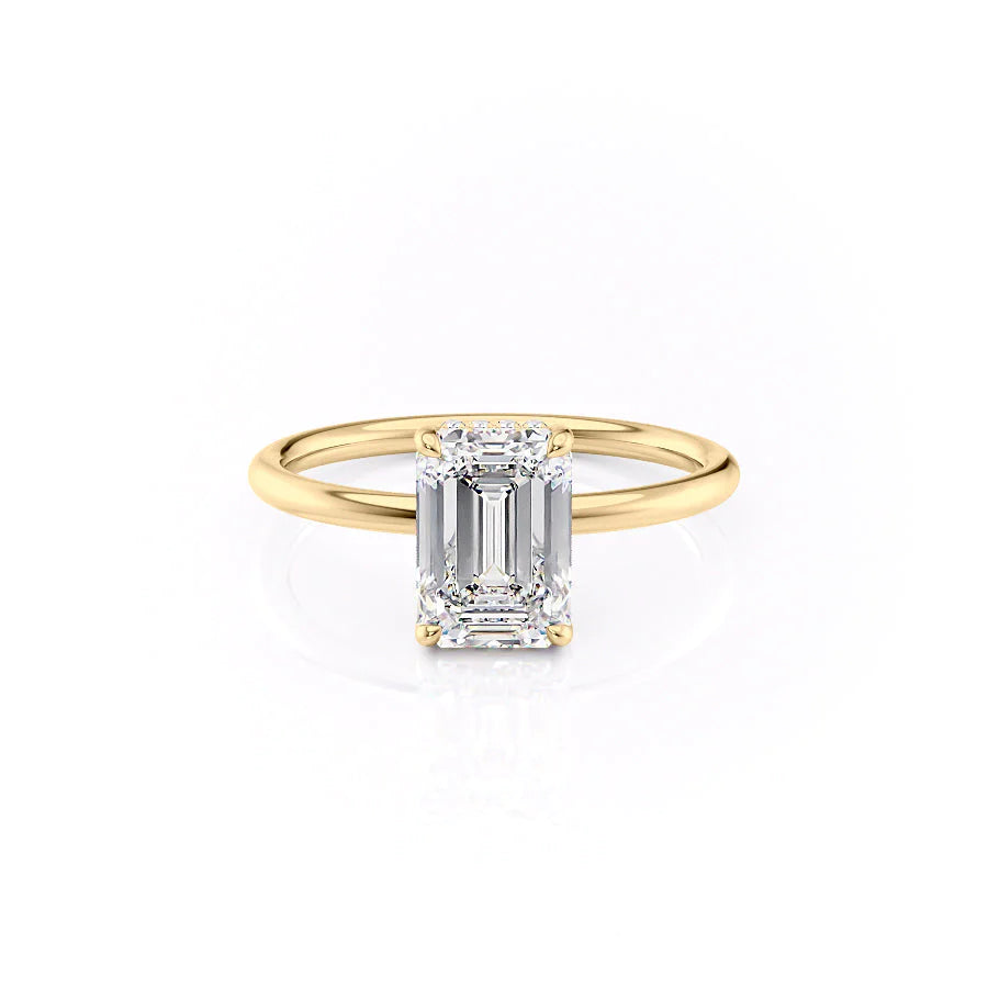 The Low Profile Kamellie. A Yellow Gold Solitaire, Hidden Halo Engagement Ring Set With A 2ct Emerald Lab Grown Diamond. White Background.