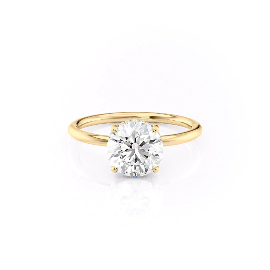 The Low Profile Kamellie. A Yellow Gold Solitaire, Hidden Halo Engagement Ring Set With A 2ct Round Lab Grown Diamond. White Background.