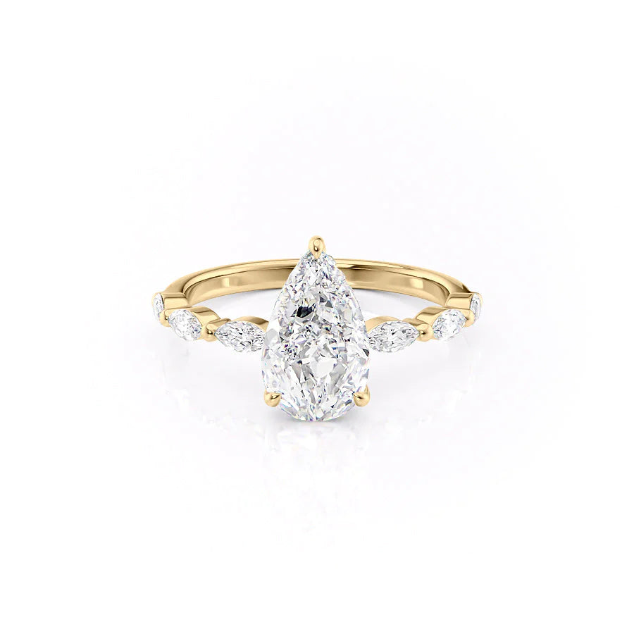 The Lucia. A Yellow Gold Side Stones, Hidden Halo Engagement Ring Set With A 2ct Pear Lab Grown Diamond. White Background.