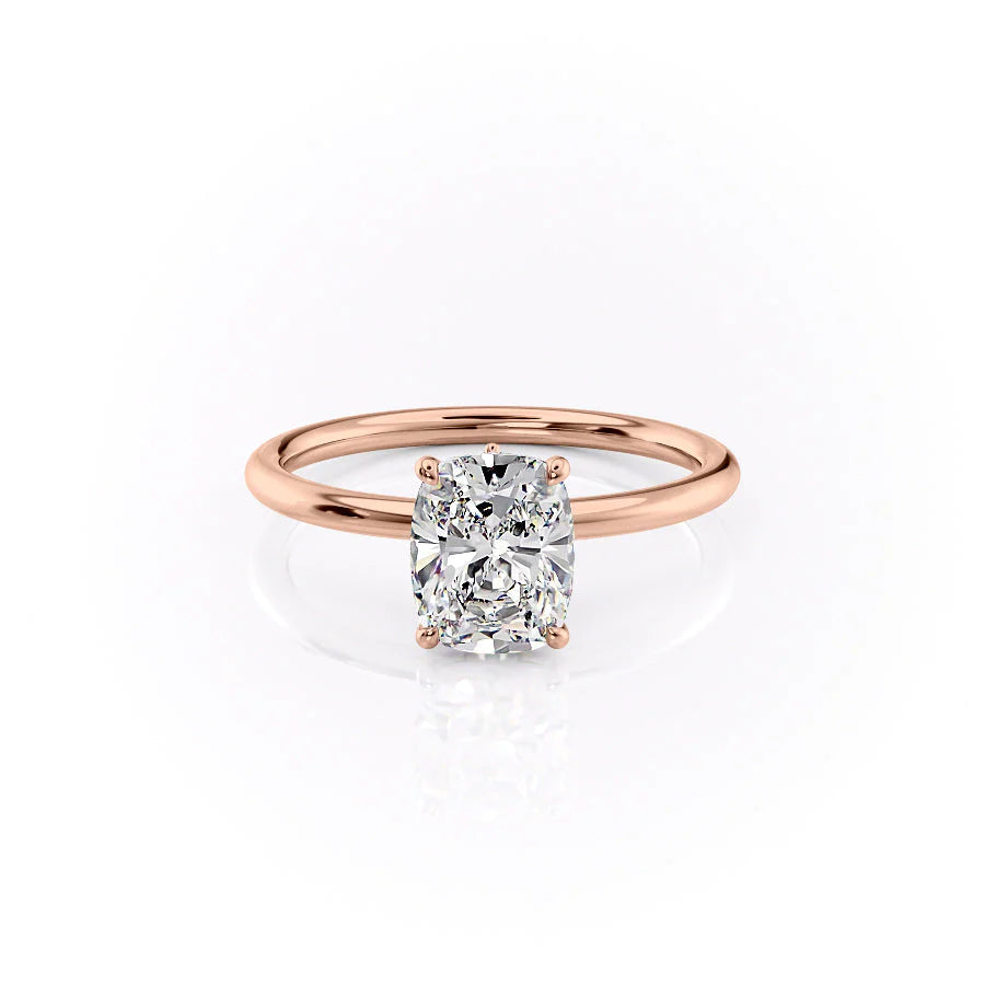 The Luna. A Rose Gold Solitaire, Nature Engagement Ring Set With A 2ct Elongated Cushion Lab Grown Diamond. White Background.