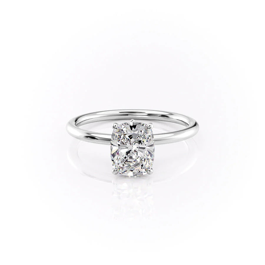 The Luna. A White Gold Solitaire, Nature Engagement Ring Set With A 2ct Elongated Cushion Lab Grown Diamond. White Background.