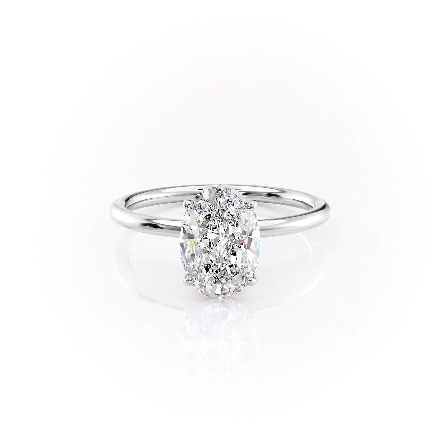 The Luna. A White Gold Solitaire, Nature Engagement Ring Set With A 2ct Oval Lab Grown Diamond. White Background.