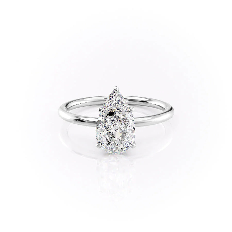 The Luna. A White Gold Solitaire, Nature Engagement Ring Set With A 2ct Pear Lab Grown Diamond. White Background.