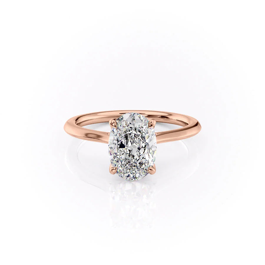 The Madison. A Rose Gold Solitaire, Nature Engagement Ring Set With A 2ct Oval Lab Grown Diamond. White Background.