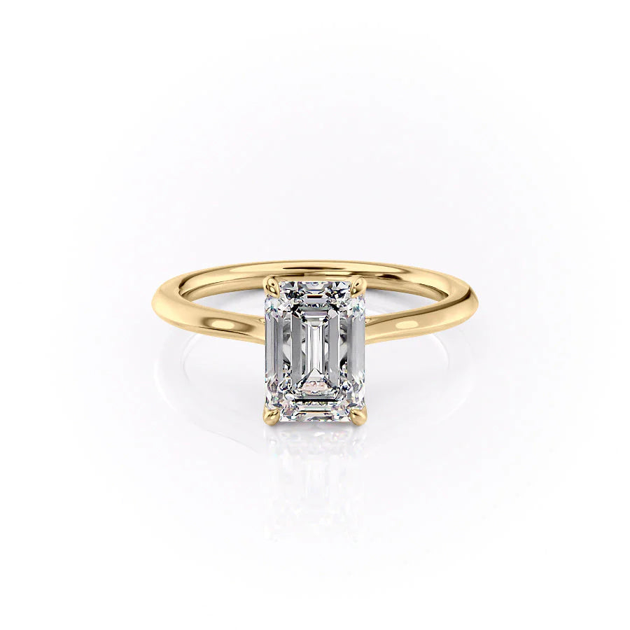 The Madison. A Yellow Gold Solitaire, Nature Engagement Ring Set With A 2ct Emerald Lab Grown Diamond. White Background.