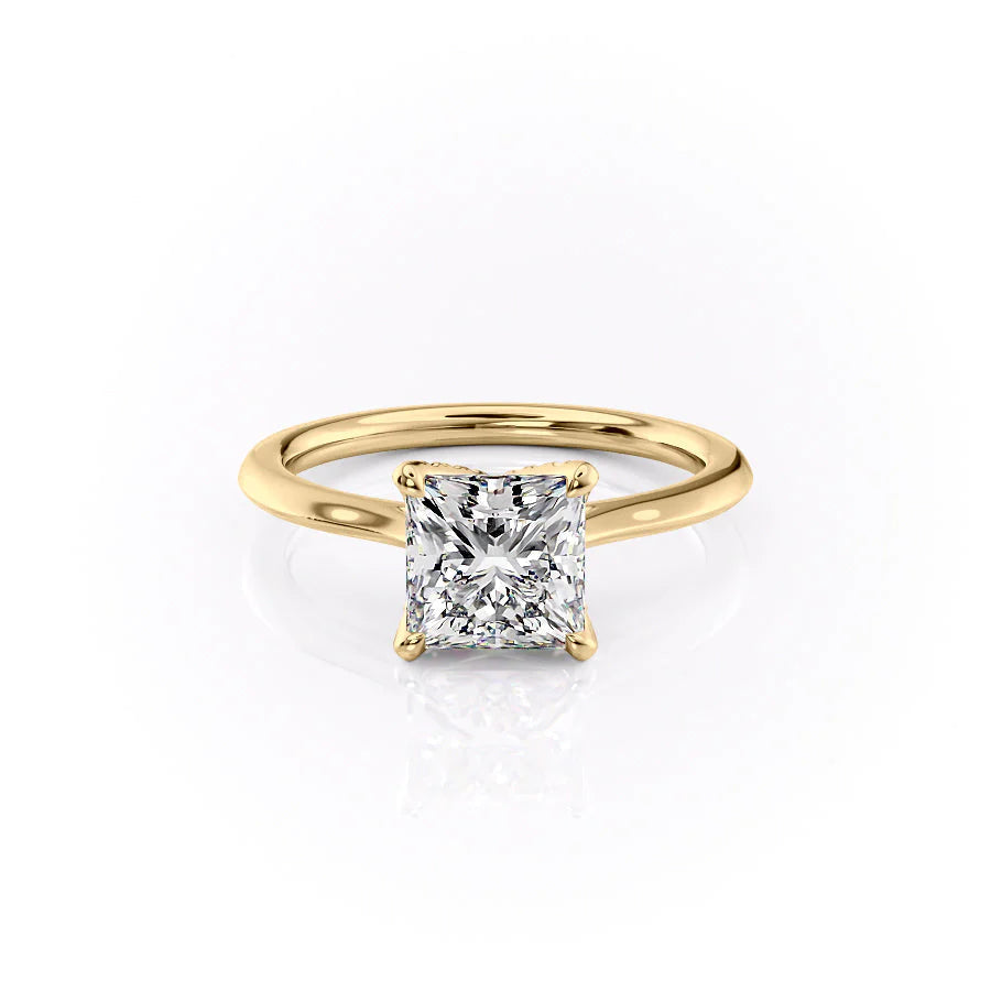 The Madison. A Yellow Gold Solitaire, Nature Engagement Ring Set With A 2ct Princess Lab Grown Diamond. White Background.