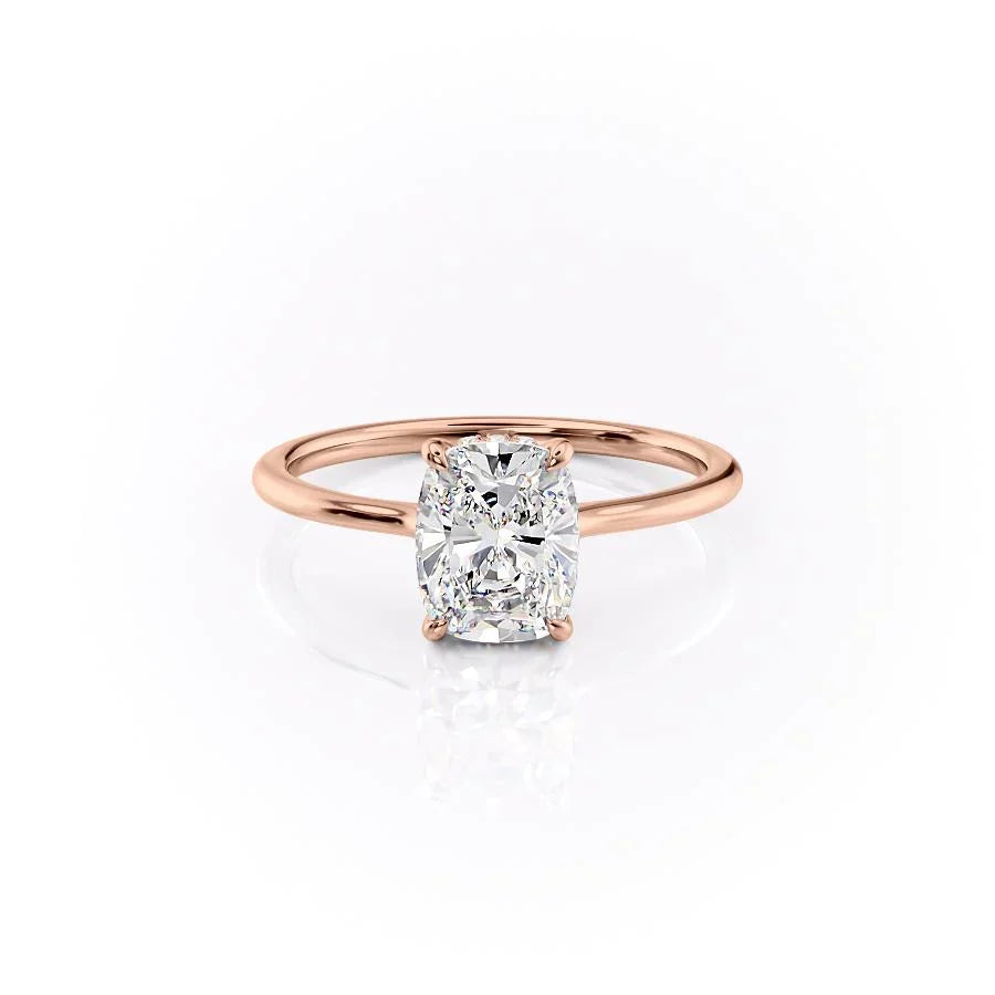 The Maia. A Rose Gold Solitaire, Hidden Halo Engagement Ring Set With A 2ct Elongated Cushion Lab Grown Diamond. White Background.