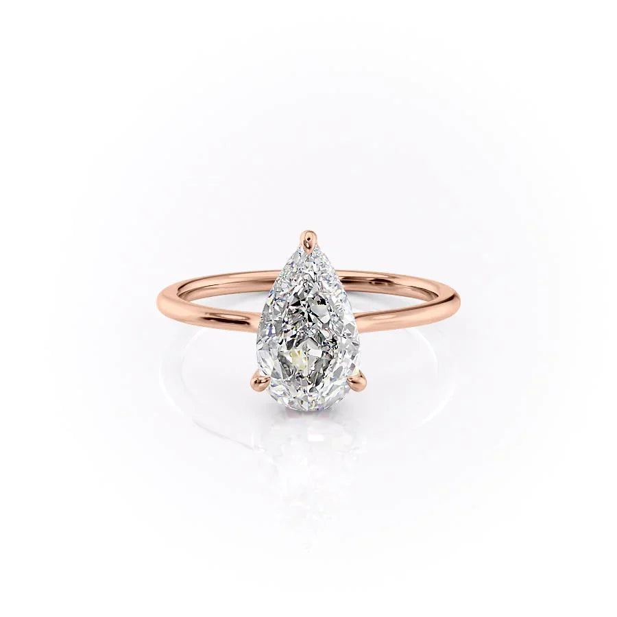 The Maia. A Rose Gold Solitaire, Hidden Halo Engagement Ring Set With A 2ct Pear Lab Grown Diamond. White Background.