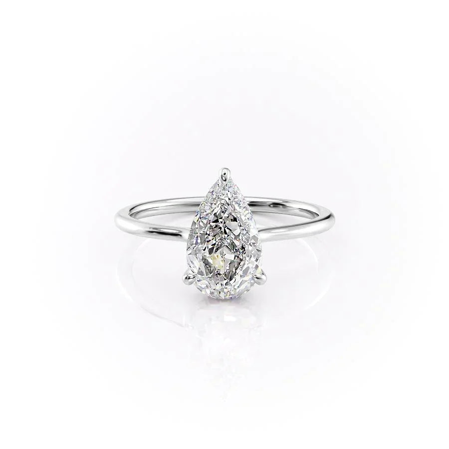 The Maia. A White Gold Solitaire, Hidden Halo Engagement Ring Set With A 2ct Pear Lab Grown Diamond. White Background.