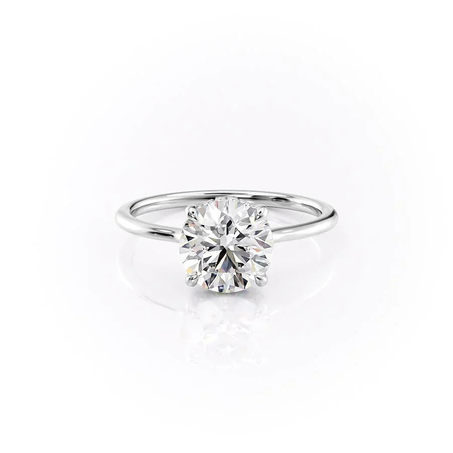 The Maia. A White Gold Solitaire, Hidden Halo Engagement Ring Set With A 2ct Round Lab Grown Diamond. White Background.