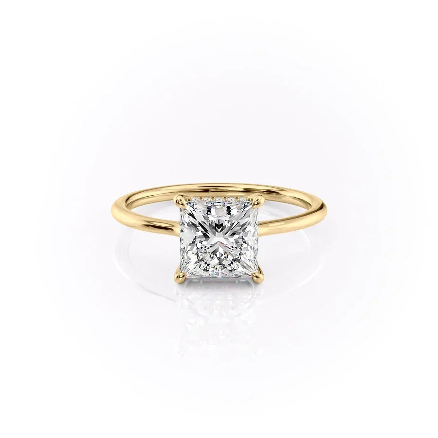 The Maia. A Yellow Gold Solitaire, Hidden Halo Engagement Ring Set With A 2ct Princess Lab Grown Diamond. White Background.