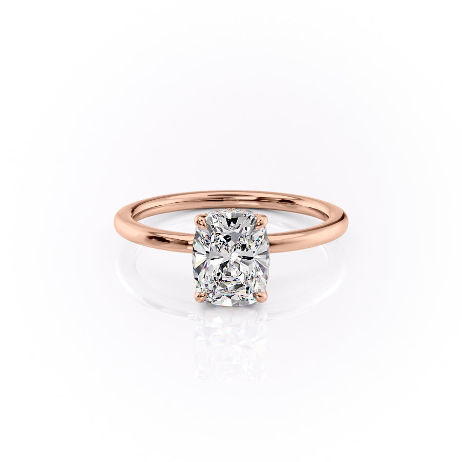 The Margot. A Rose Gold Solitaire, Hidden Halo Engagement Ring Set With A 2ct Elongated Cushion Lab Grown Diamond. White Background.