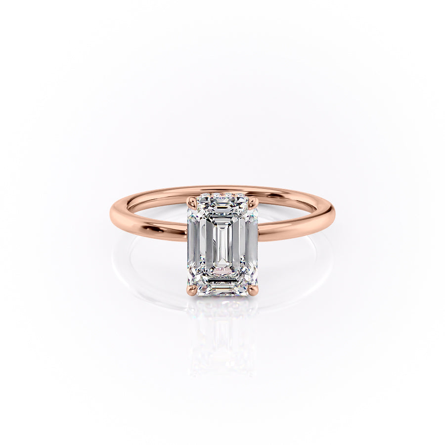 The Margot. A Rose Gold Solitaire, Hidden Halo Engagement Ring Set With A 2ct Emerald Lab Grown Diamond. White Background.