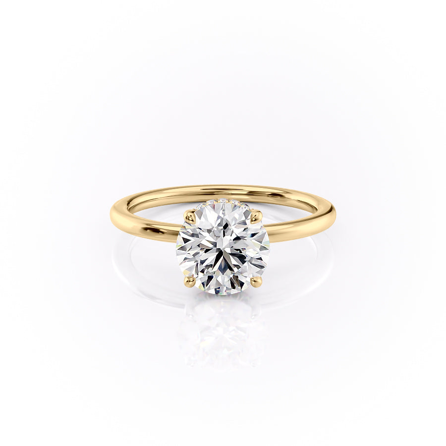 The Margot. A Yellow Gold Solitaire, Hidden Halo Engagement Ring Set With A 2ct Round Lab Grown Diamond. White Background.