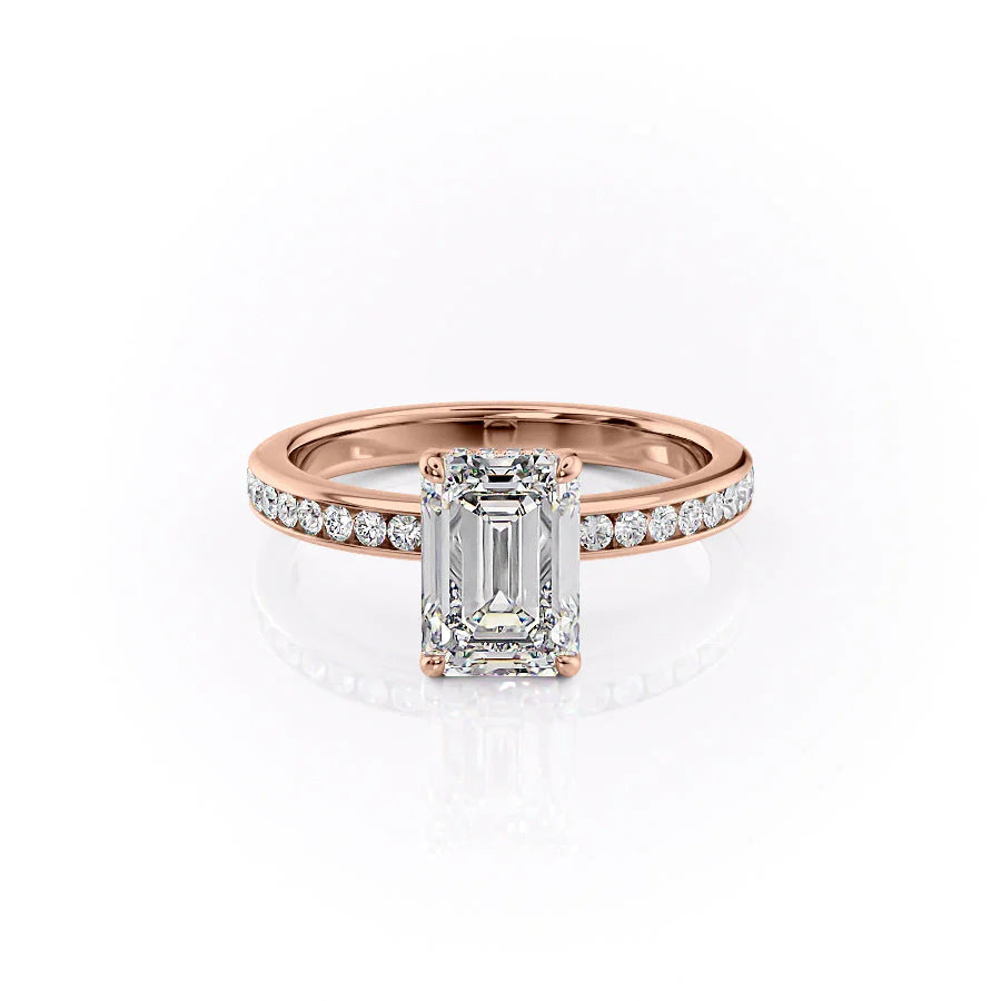 The Marilyn. A Rose Gold Channel-Set, Side Stones, Hidden Halo Engagement Ring Set With A 2ct Emerald Lab Grown Diamond. White Background.