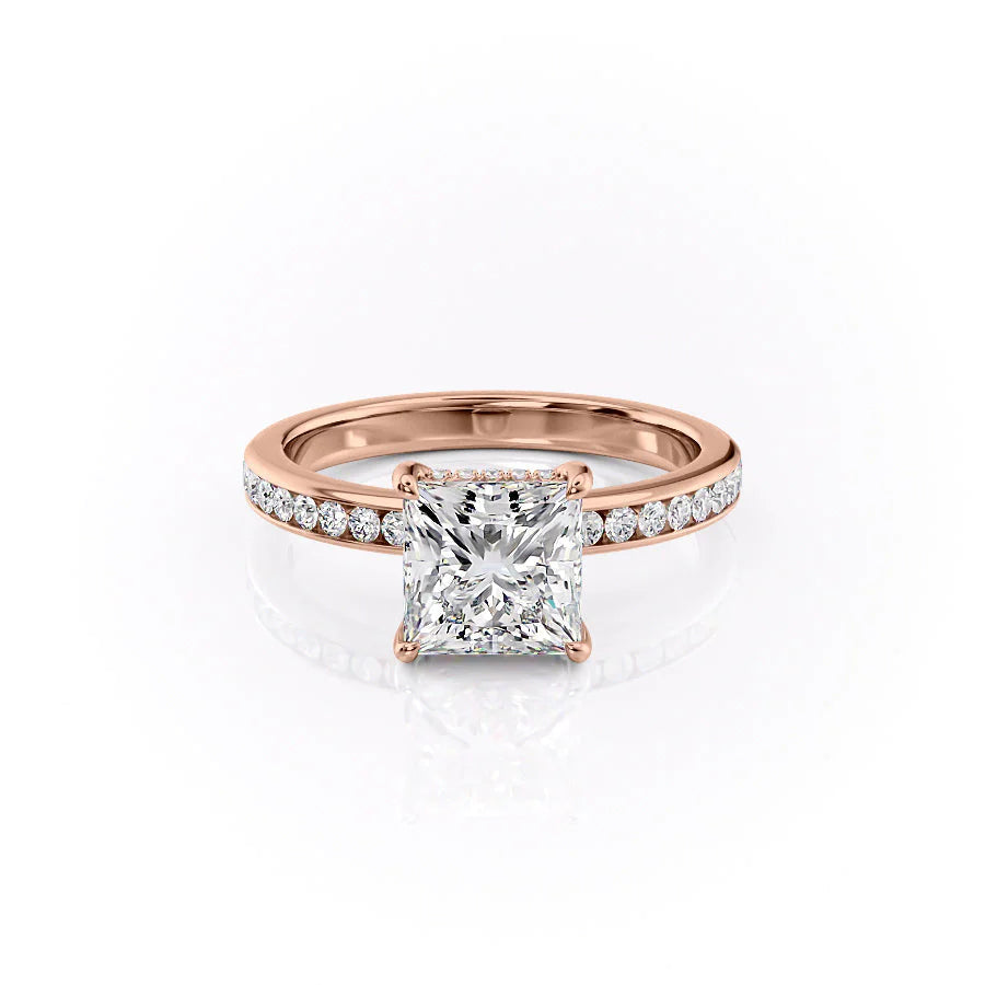 The Marilyn. A Rose Gold Channel-Set, Side Stones, Hidden Halo Engagement Ring Set With A 2ct Princess Lab Grown Diamond. White Background.