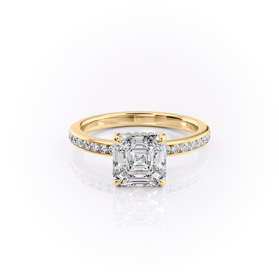 The Marilyn. A Yellow Gold Channel-Set, Side Stones, Hidden Halo Engagement Ring Set With A 2ct Asscher Lab Grown Diamond. White Background.
