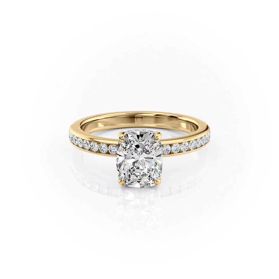 The Marilyn. A Yellow Gold Channel-Set, Side Stones, Hidden Halo Engagement Ring Set With A 2ct Elongated Cushion Lab Grown Diamond. White Background.