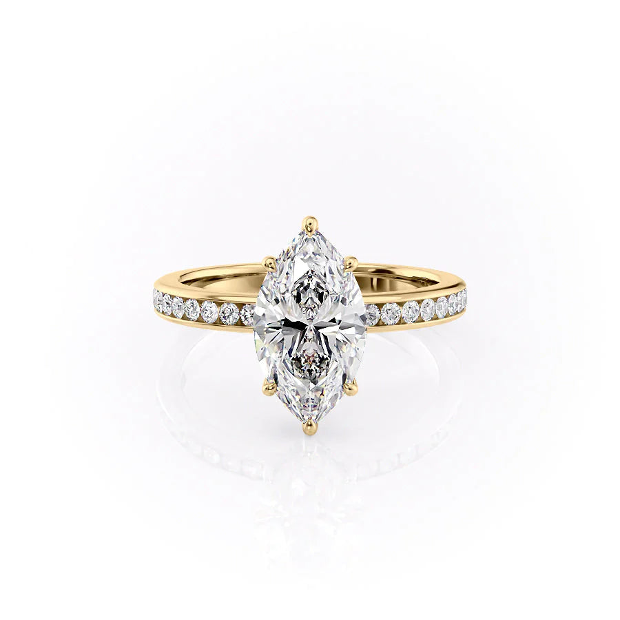 The Marilyn. A Yellow Gold Channel-Set, Side Stones, Hidden Halo Engagement Ring Set With A 2ct Marquise Lab Grown Diamond. White Background.