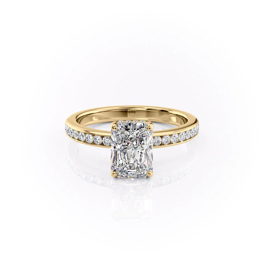The Marilyn. A Yellow Gold Channel-Set, Side Stones, Hidden Halo Engagement Ring Set With A 2ct Radiant Lab Grown Diamond. White Background.