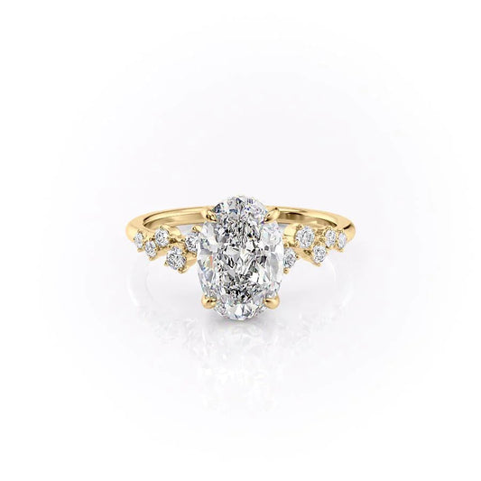 The Mia. A Yellow Gold Side Stones, Hidden Halo Engagement Ring Set With A 2ct Oval Lab Grown Diamond. White Background.