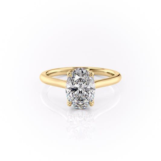 The Morgan. A Yellow Gold Hidden Halo, Solitaire, Nature Engagement Ring Set With A 2ct Oval Lab Grown Diamond. White Background.