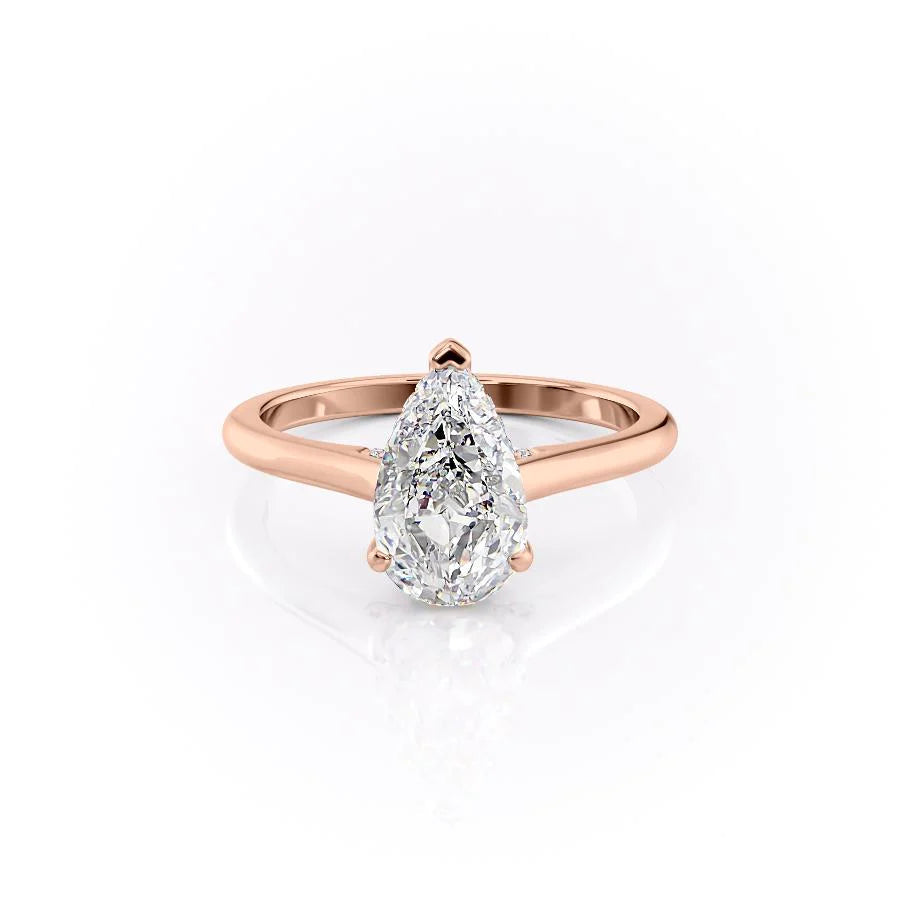 The Natalie. A Rose Gold Solitaire, Hidden Halo Engagement Ring Set With A 2ct Pear Lab Grown Diamond. White Background.