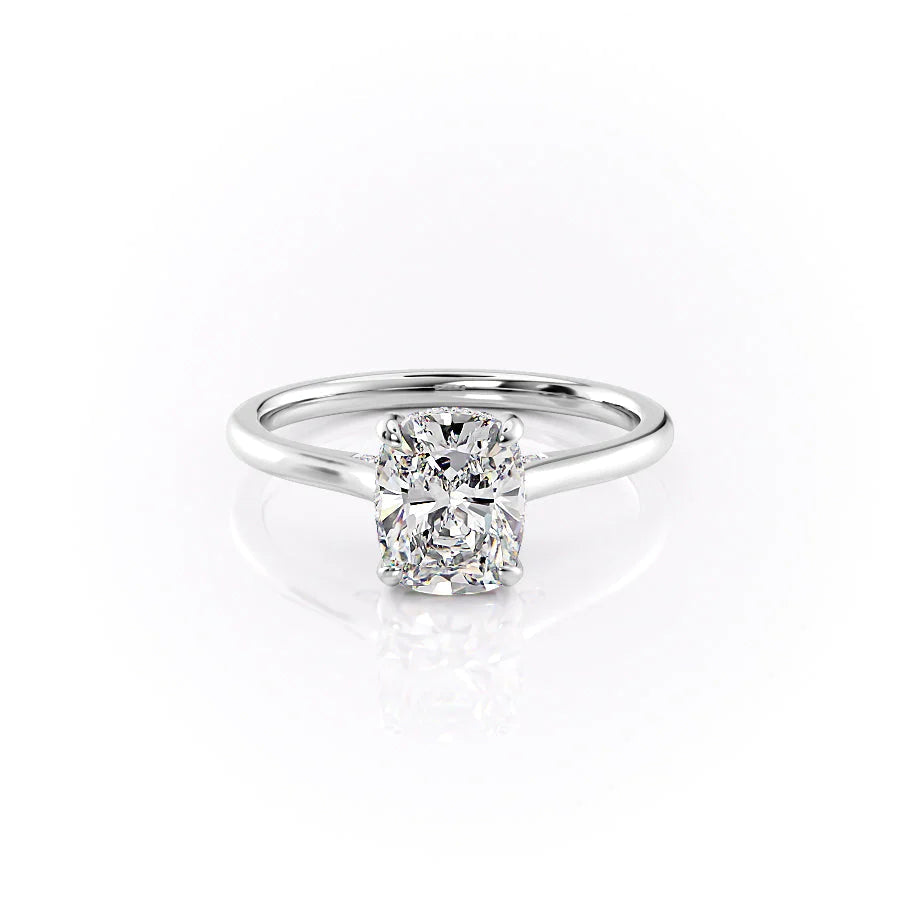 The Natalie. A White Gold Solitaire, Hidden Halo Engagement Ring Set With A 2ct Elongated Cushion Lab Grown Diamond. White Background.