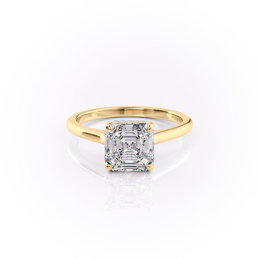 The Natalie. A Yellow Gold Solitaire, Hidden Halo Engagement Ring Set With A 2ct Asscher Lab Grown Diamond. White Background.