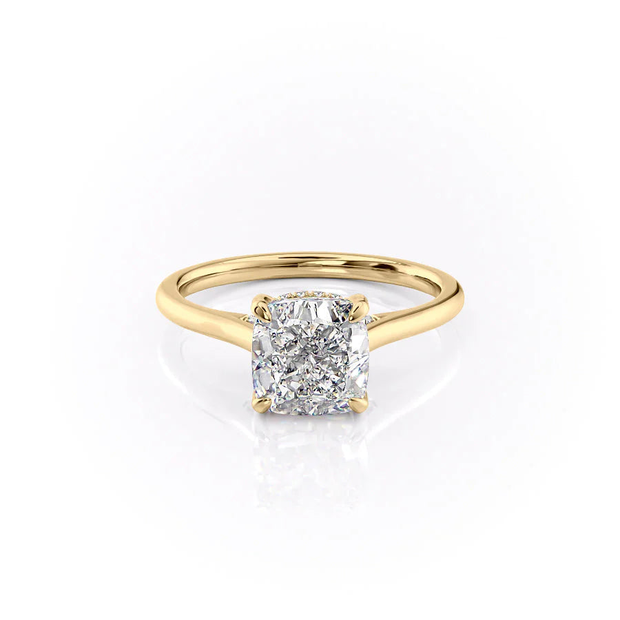 The Natalie. A Yellow Gold Solitaire, Hidden Halo Engagement Ring Set With A 2ct Cushion Lab Grown Diamond. White Background.