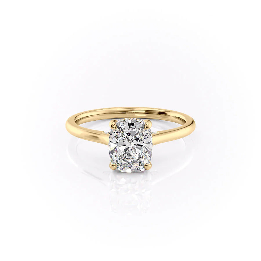 The Natalie. A Yellow Gold Solitaire, Hidden Halo Engagement Ring Set With A 2ct Elongated Cushion Lab Grown Diamond. White Background.