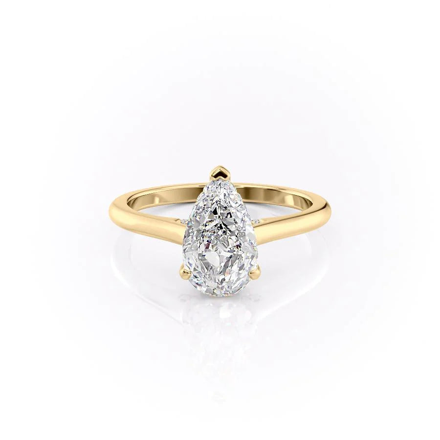 The Natalie. A Yellow Gold Solitaire, Hidden Halo Engagement Ring Set With A 2ct Pear Lab Grown Diamond. White Background.