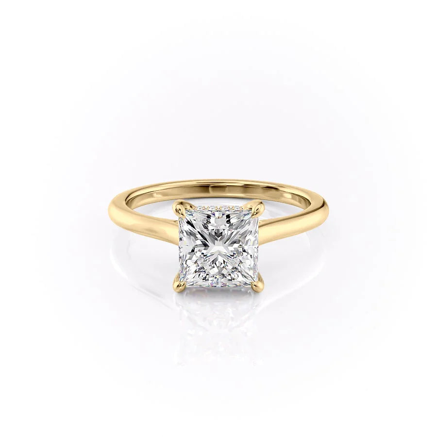 The Natalie. A Yellow Gold Solitaire, Hidden Halo Engagement Ring Set With A 2ct Princess Lab Grown Diamond. White Background.