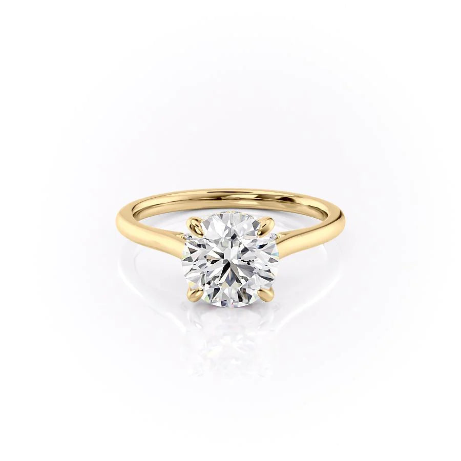 The Natalie. A Yellow Gold Solitaire, Hidden Halo Engagement Ring Set With A 2ct Round Lab Grown Diamond. White Background.