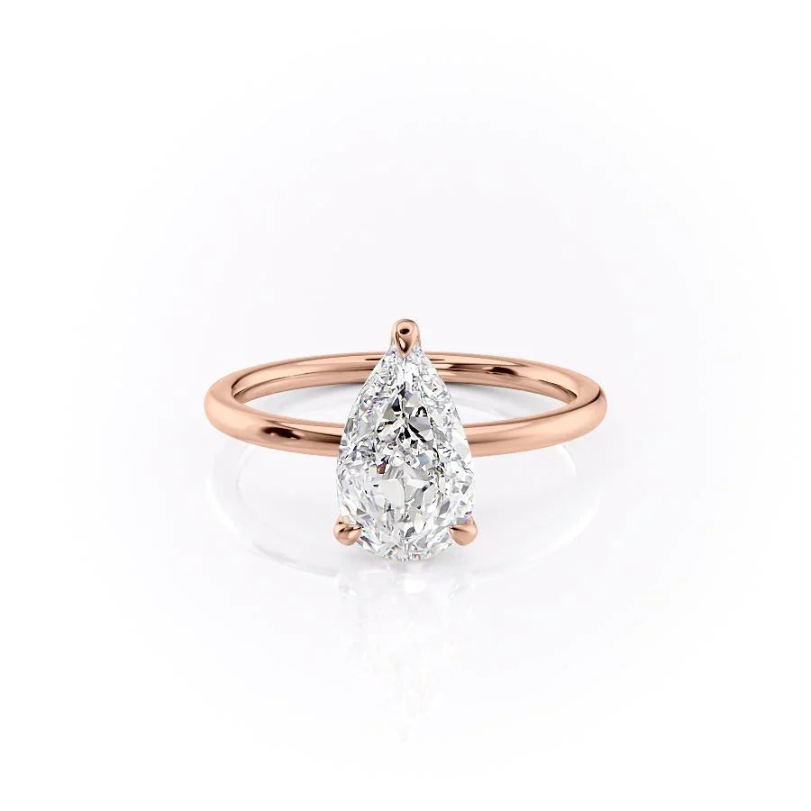 The Nelly. A Rose Gold Solitaire, Hidden Halo Engagement Ring Set With A 2ct Pear Lab Grown Diamond. White Background.