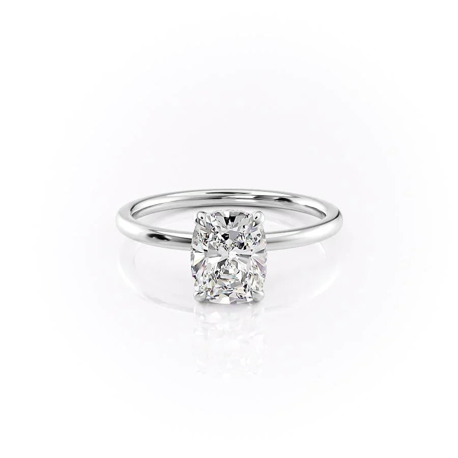 The Nelly. A White Gold Solitaire, Hidden Halo Engagement Ring Set With A 2ct Elongated Cushion Lab Grown Diamond. White Background.